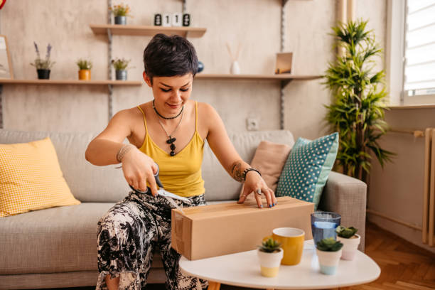 istock Woman customer opening cardboard box parcel 1330959450