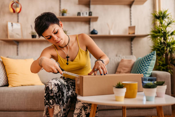 istock Woman customer opening cardboard box parcel 1330959540