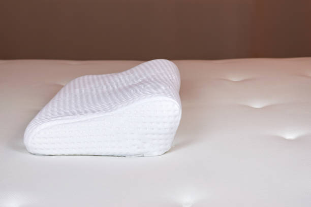 istock White orthopedic pillow on a white mattress. Orthopedic pillow with memory effect. Orthopedics, healthy sleep 1330959713