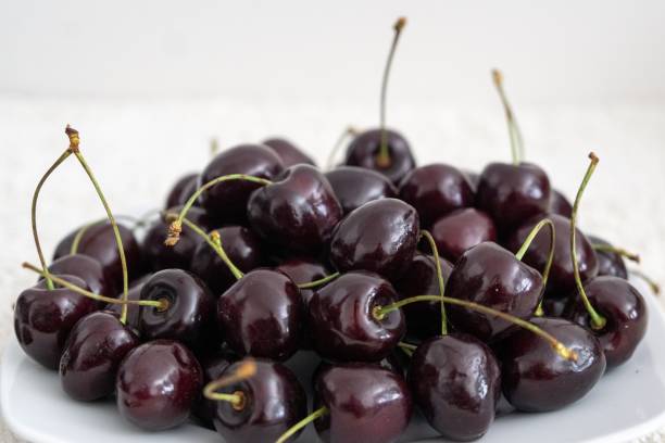 istock Ripe red cherries fruit macro isolated on the plate. 1330960461