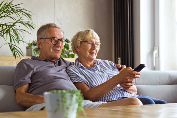 istock Senior couple watching tv at home 1330961679
