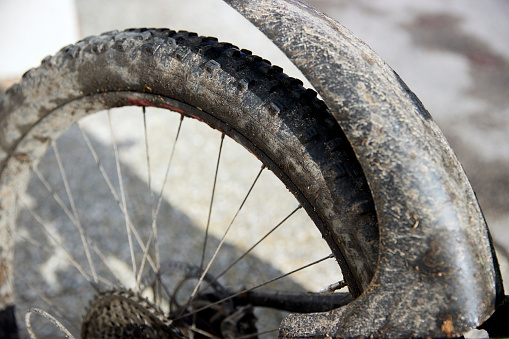 Full frame daylight image of dirty bicycle wheel in Germany