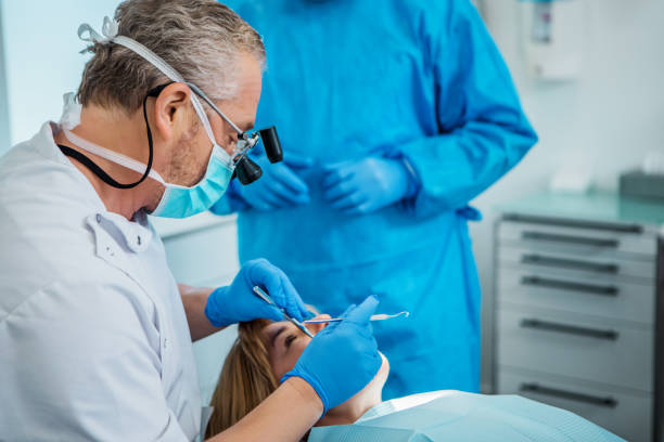 istock A dentist and assistant working on a patient in a dental surgery 1330963032