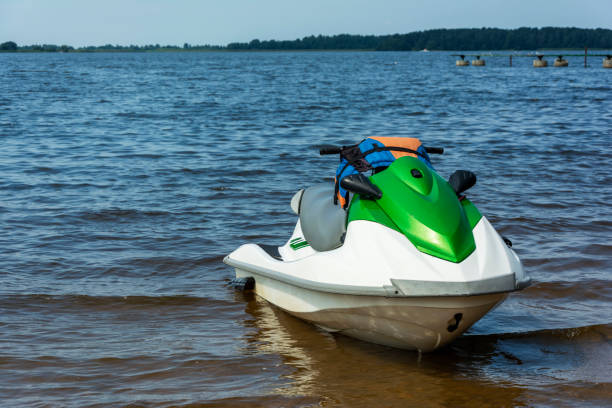 Beautiful green jet ski on the lake, jet skiing, active lifestyle, summer, water, heat, vacation stock photo