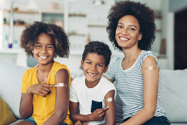 istock Smiling mother and two children got vaccinated 1330966682