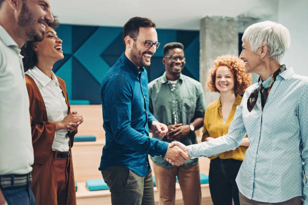 Taking the new opportunity Smiling business persons shaking hands overseeing stock pictures, royalty-free photos & images