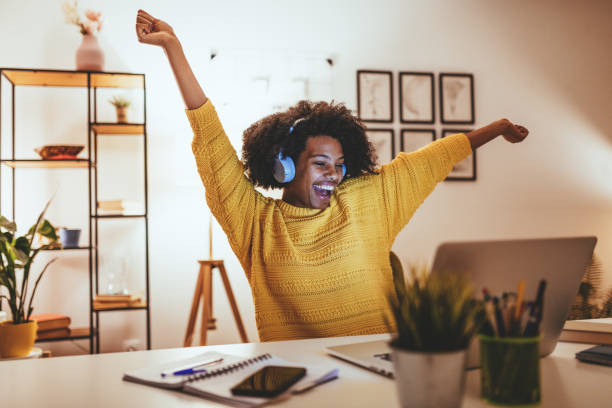 istock Cheerful African American woman using laptop to work from home 1330967535