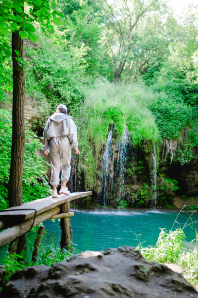 istock woman hiker enjoying view of waterfall 1330967708