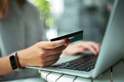 Woman with credit card and laptop