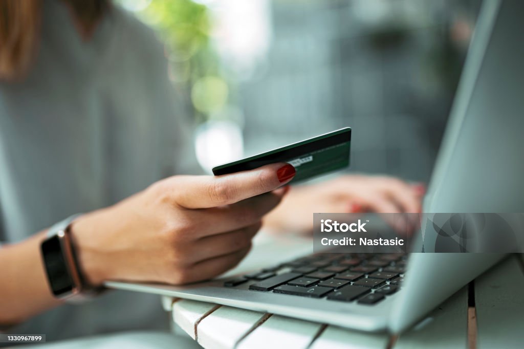 Young woman with credit card and laptop Woman with credit card and laptop Credit Card Stock Photo
