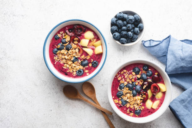 istock Purple vegan smoothie bowl with blueberries and granola 1330969942