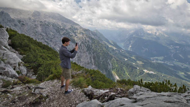 istock Teenager Capturing Mountaintop View 1330971149