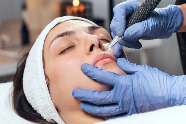 istock Cosmetologist making micropigmentation injection on face for rejuvenation while lying on a stretcher in the spa center. 1330973994