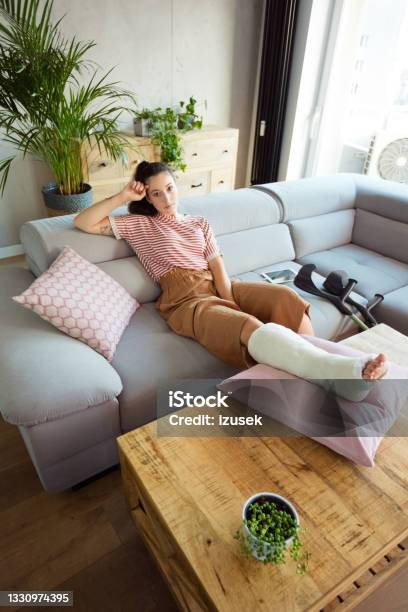 Young Woman With Broken Leg At Home Stock Photo - Download Image Now - Broken Leg, Orthopedic Cast, Domestic Life