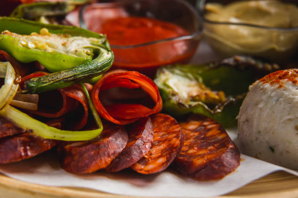 istock Assorted meat and sausages and grilled vegetables on a round plate 1330975187