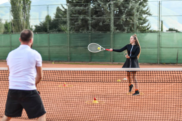 istock Female Tennis Player Practicing New Moves With Teacher 1330976014
