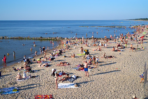 Zelenogradsk, Kaliningrad region, Russia - June 18, 2021: Unknown people resting and sunbathing on a sandy beach on the Baltic Sea coast in famous resort Zelenogradsk (formerly known as Cranz) at summer time