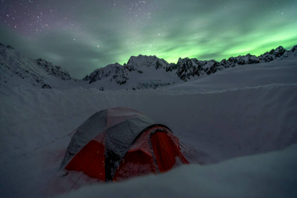 istock Scenic view of camp under northern lights 1330977365