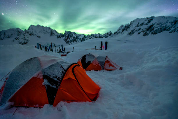 istock Scenic view of camp under northern lights 1330977377
