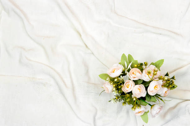 istock Beautiful flower bouquet on bed in light room. Space for text 1330978413