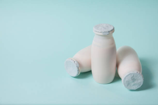 istock Bottles with probiotics and prebiotics dairy drink on light blue background. 1330980300