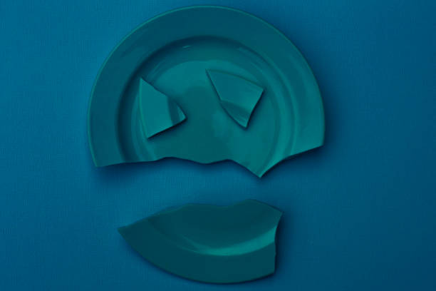 istock Blue broken plate on a blue background. Family relationship concept, divorce, horror 1330980411