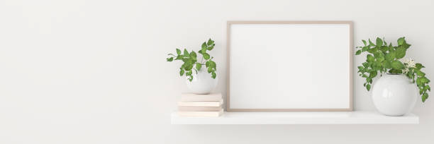 istock Empty picture frame mockup on a shelf with books and plants. Web banner format with copy space. 1330981179