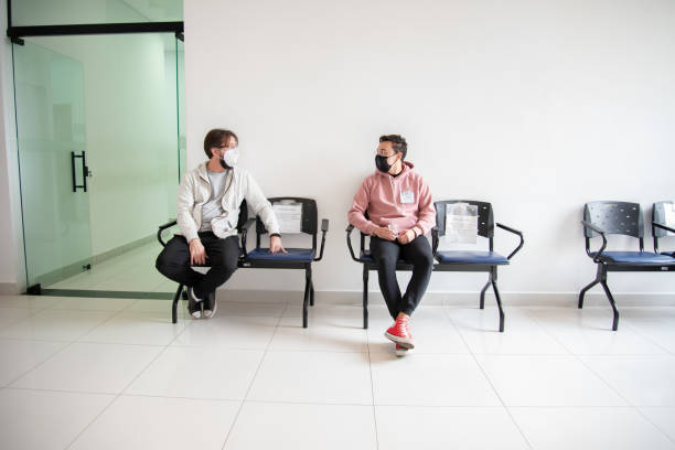 istock two men wearing protective masks in the donation waiting room 1330982455