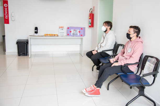 istock two men wearing protective masks in the donation waiting room 1330982462