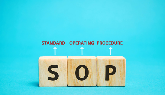 Wooden blocks with the word SOP ( Standard operating procedure ). Instructions to assist employees in complex routine operations. Business concept