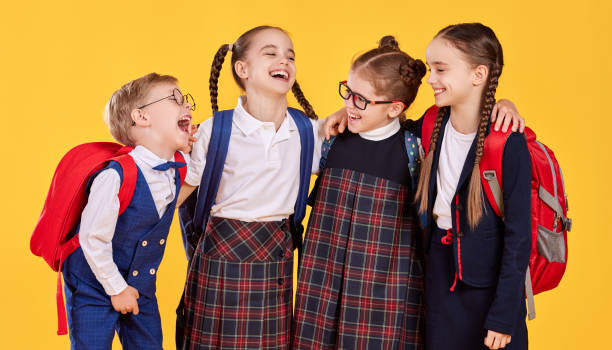 istock Cheerful youngsters in school uniform laughing together 1330984141