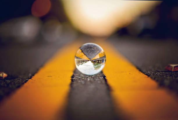 Crystal ball reflecting a double yellow on a neighborhood street