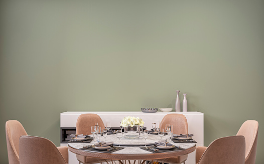 Modern luxury dining room with full round table, chairs, low cabinets and decoration in front of khaki / olive green plaster wall background. 3D rendered image.