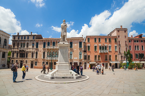 Venice, Italy - June 15, 2016: bright sunny day in Venice, view of statue of Nicolo Tommaseo on St. Stephen's square (campo Santo Stefano)