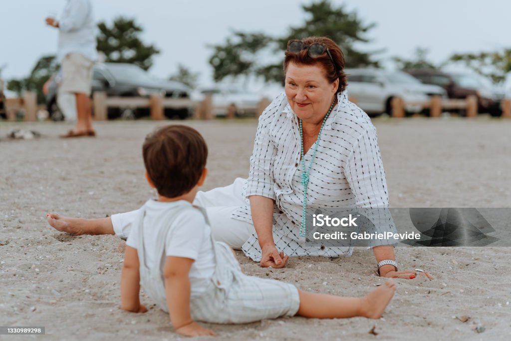 Grandmother playing with her grandson on the beach Aunt Stock Photo