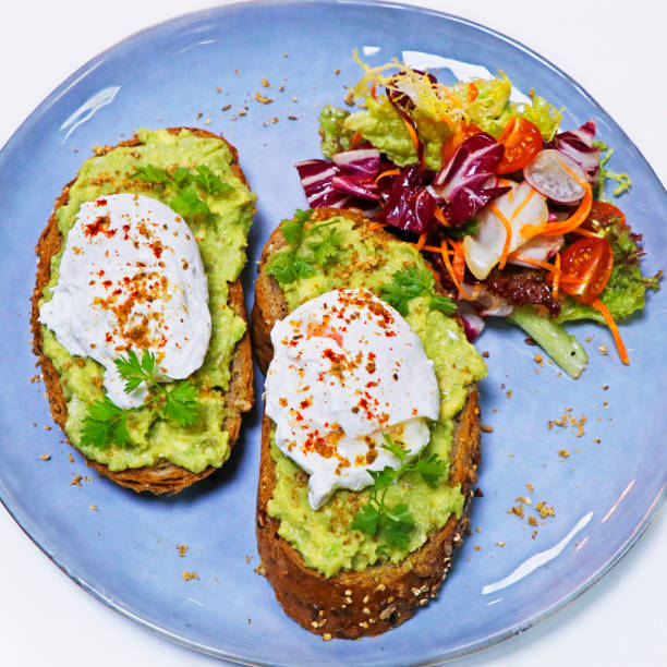 istock Scrambled organic eggs on toasted bread with asparagus, tomato and mixed lettuce, summer breakfast 1330989330