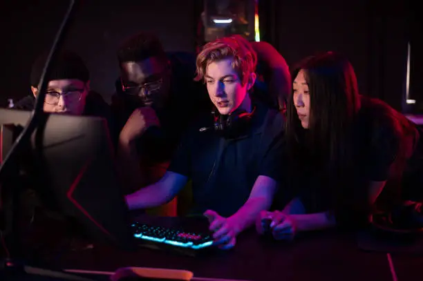 Photo of Players of the esports team gathered together in the computer club and watch the stream from the dota 2 world championship