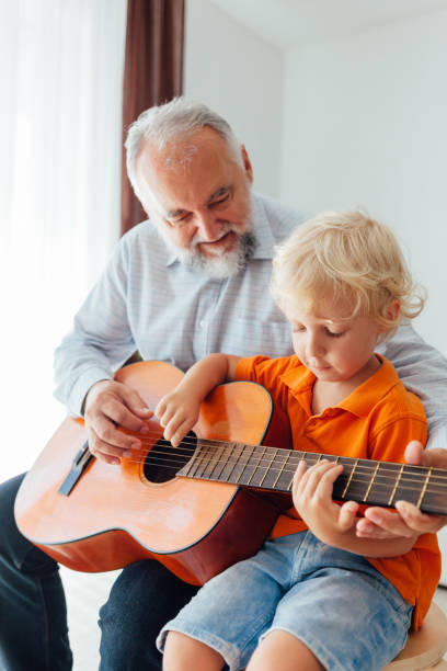 istock Grandpa Learning His Grandson To Play Guitar 1330990097
