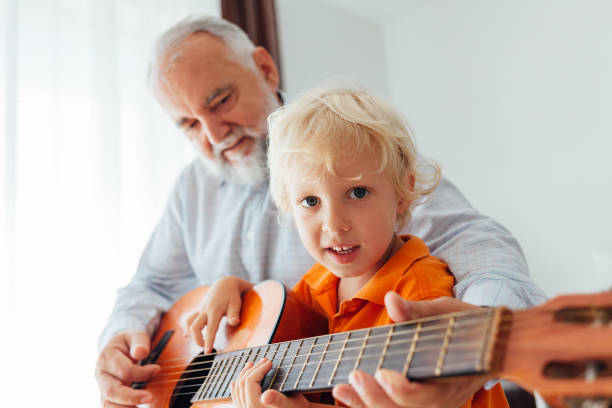 istock Little Boy Play The Guitar 1330990665