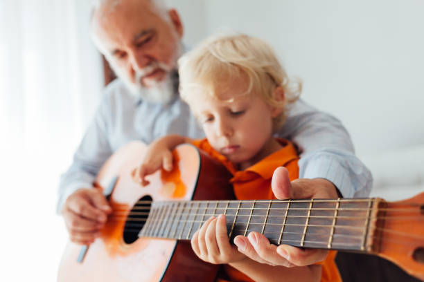 istock Grandfather And Grandson Playing Guitar 1330991222