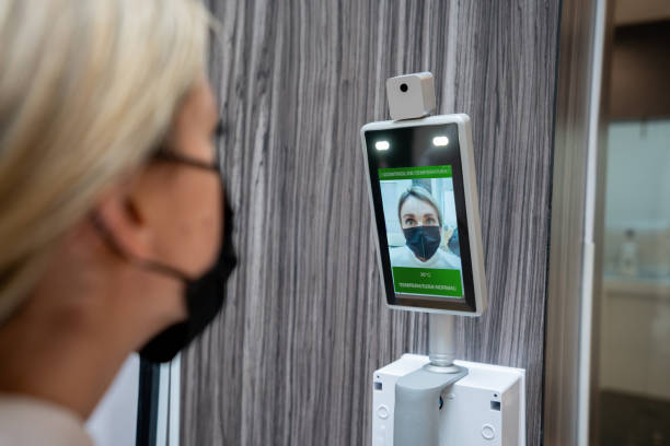 istock Woman getting her temperature checked before entering the mall 1330995601