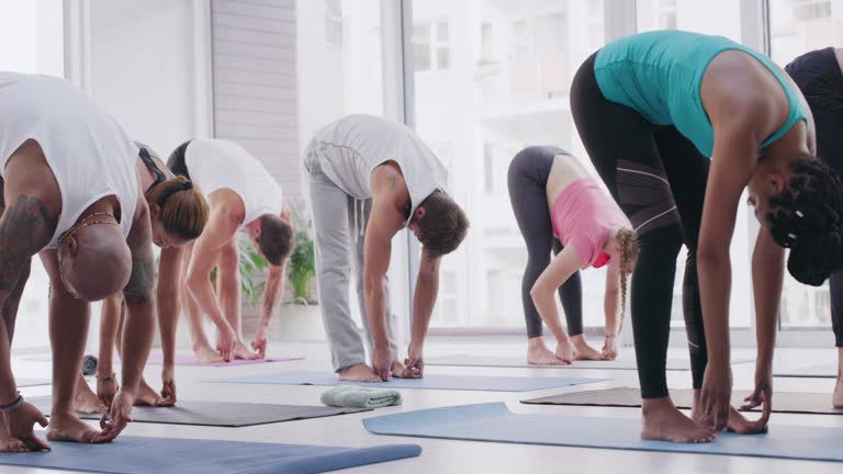 4k video footage of a group of people practising yoga in a fitness class