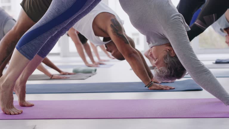 4k video footage of a group of people practising yoga in a fitness class