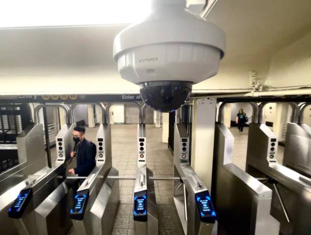 Security Video Surviellance Camera in Subway Entrance New York, NY  USA - May 14, 2021: New York City, Turnstiles and Surveillance Camera in New York Subway Station subway photos stock pictures, royalty-free photos & images
