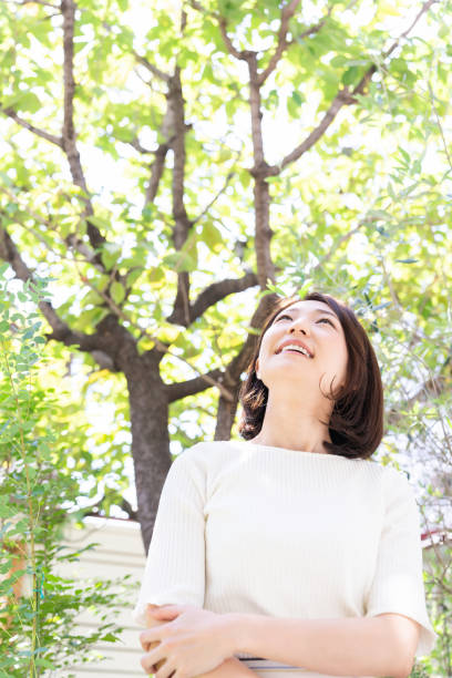 istock attractive asian woman relaxing, garden 1331007211