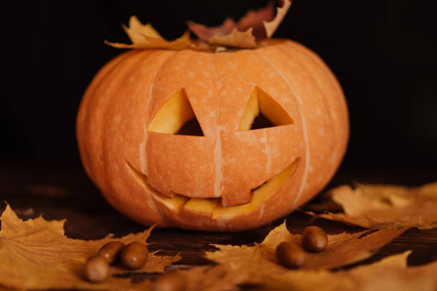istock Halloween orange pumpkin with maple leaves and acorns 1331007681