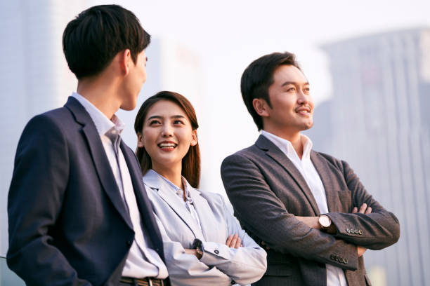 istock asian corporate executives chatting relaxing outdoors 1331008583