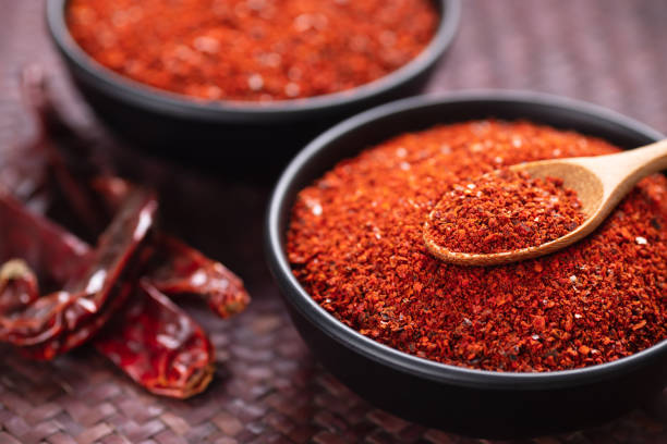 istock Red chili pepper powder in a bowl with spoon 1331009572