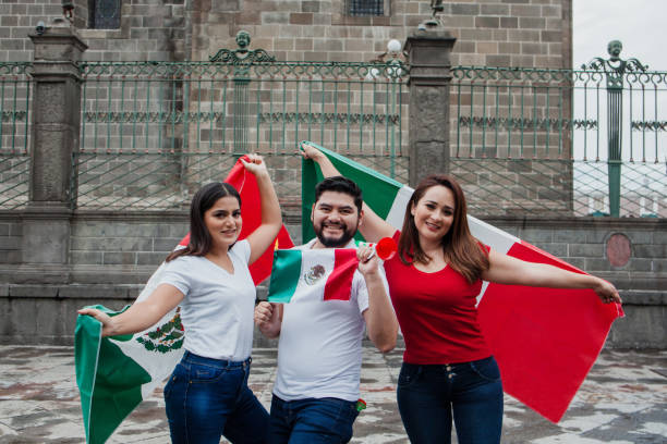 istock Young mexican people holding some flags in Mexico City 1331011331