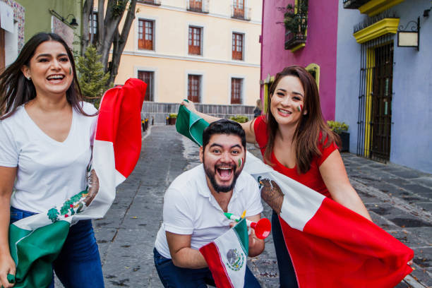istock Young mexican soccer fans holding flags in Mexico 1331012155